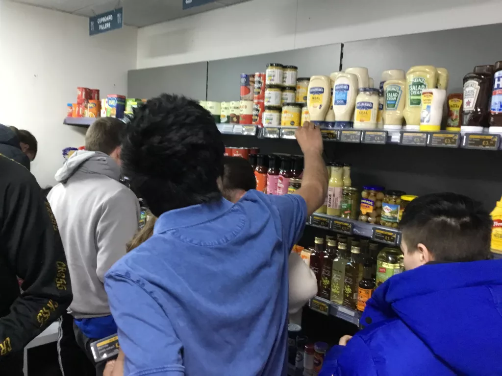 Shoppers at grocery shelves with Displaydata ESLs providing clear, accessible product information
